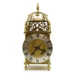 A reproduction brass lantern clock