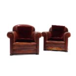 A pair of red leather club chairs