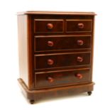 An Edwardian miniature mahogany chest of drawers,