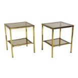 A pair of two tiered brass side tables,
