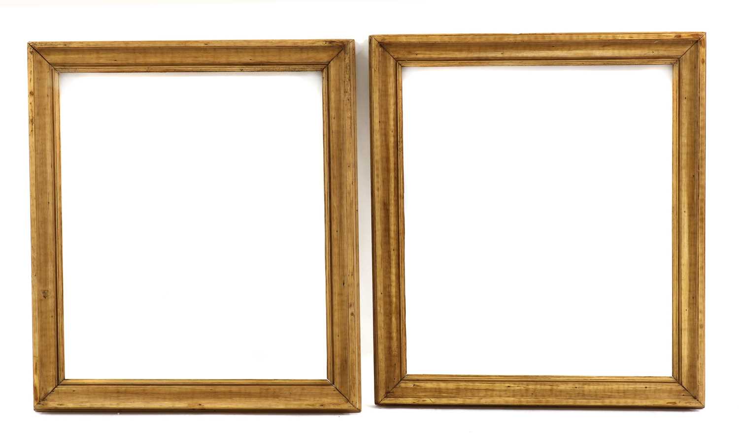 A pair of stripped pine frames,