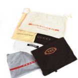 A collection of various designer shoe and bag dust bags,