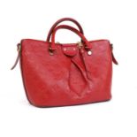 A Louis Vuitton red Mazarine monogrammed Empreinte leather PM bag,