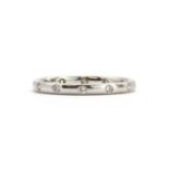 An 18ct white gold diamond gypsy set wedding ring,