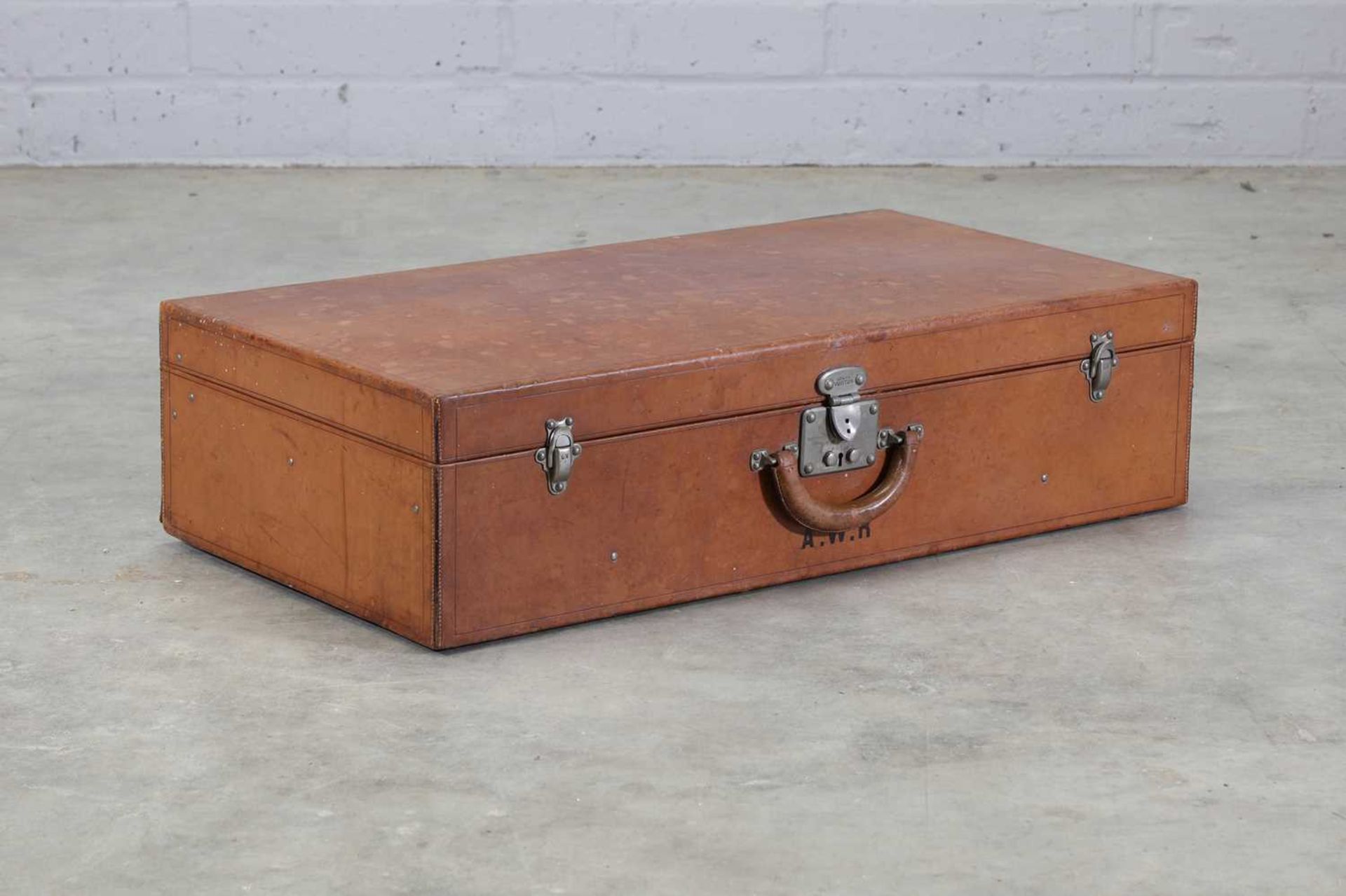 A Louis Vuitton tan leather suitcase,