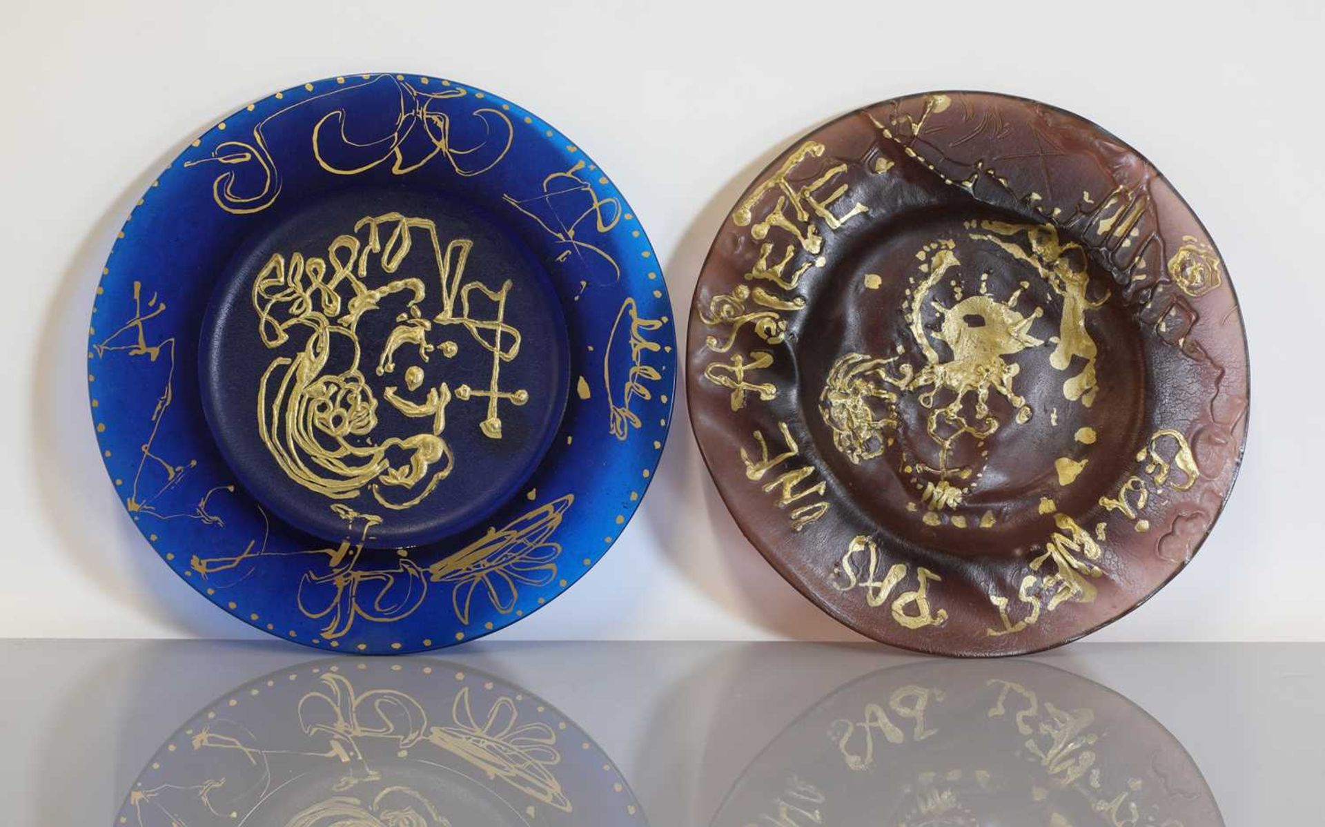 Two Daum molten glass plates 'Triomphe' and 'Ceci n'est pas une Assiette',