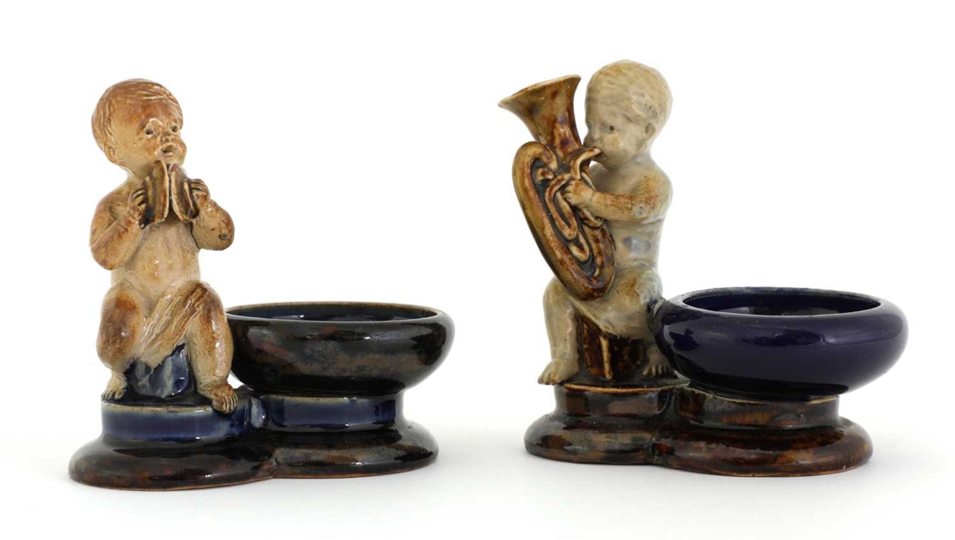 Two Doulton stoneware figural salts,