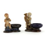 Two Doulton stoneware figural salts,