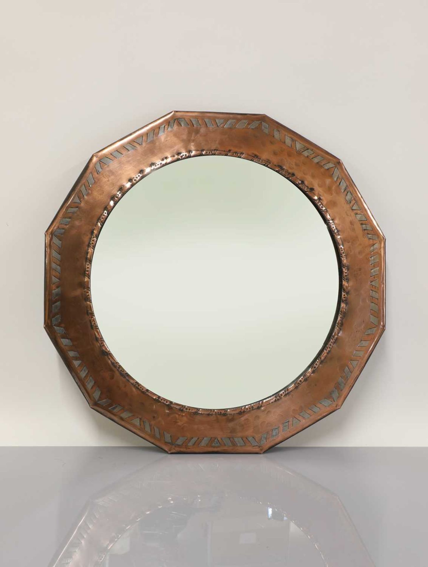 An Hugh Wallis dodecahedral Arts & Crafts mirror,