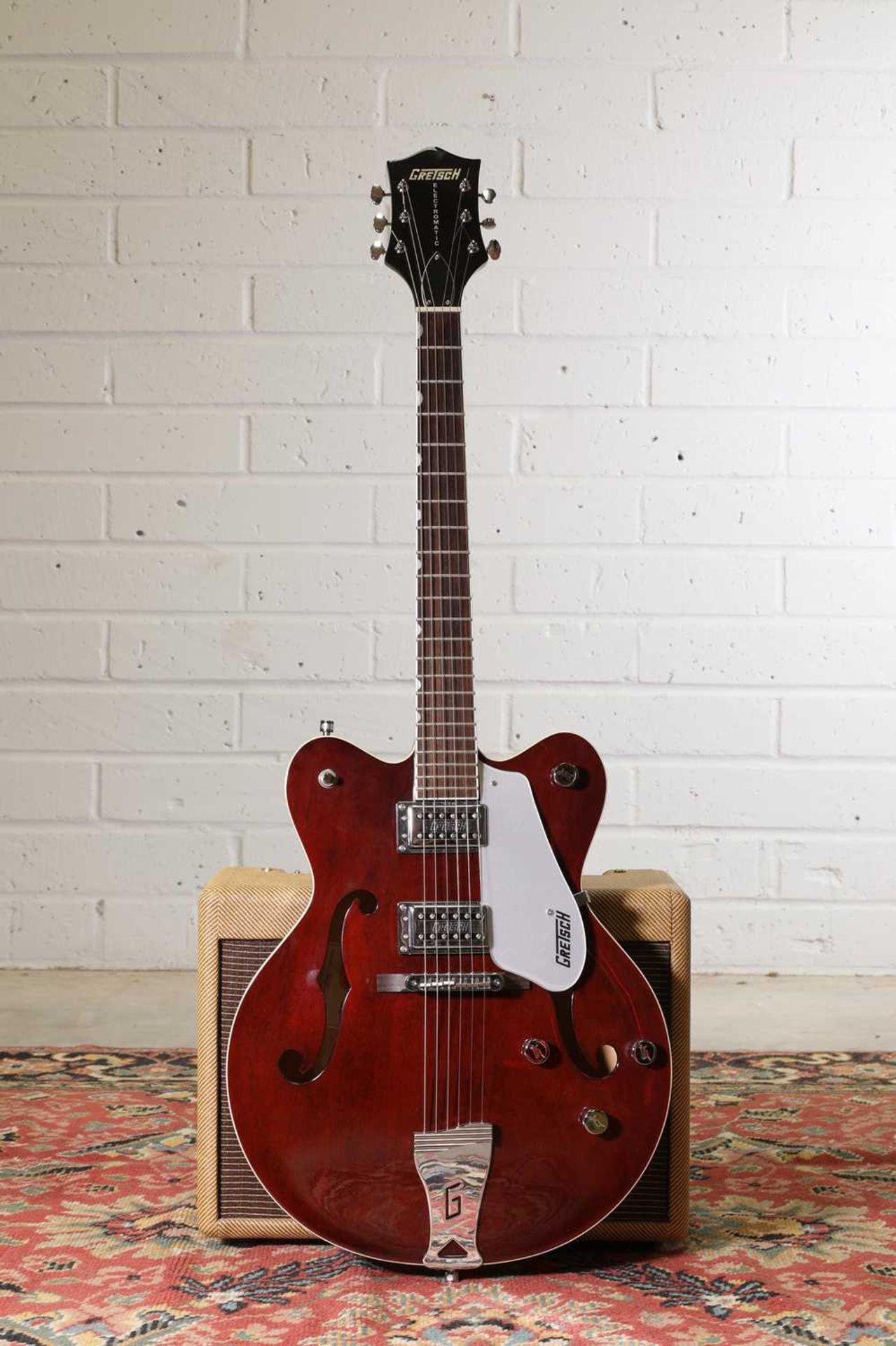 A Gretsch Electromatic semi-hollow electric guitar,