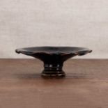 A Chinese black-glazed stoneware stem cup,