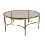 A Maison Jansen style brass and smoked glass coffee table