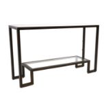 A tubular metal and glass console table
