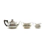 A silver three piece tea service