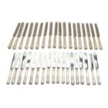 A set of silver-handled table knives,