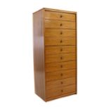 A slender teak chest of drawers,