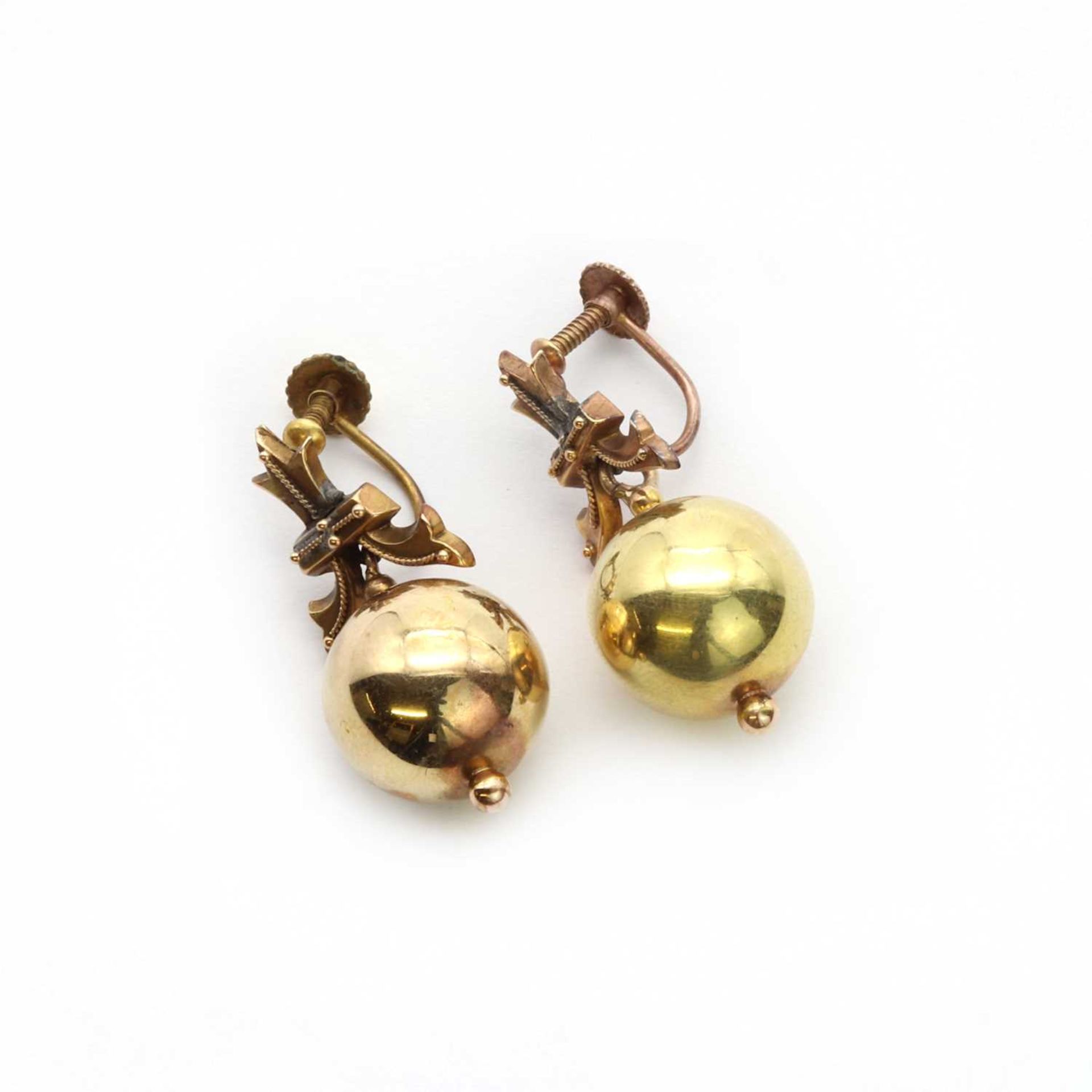 A pair of gold drop earrings,