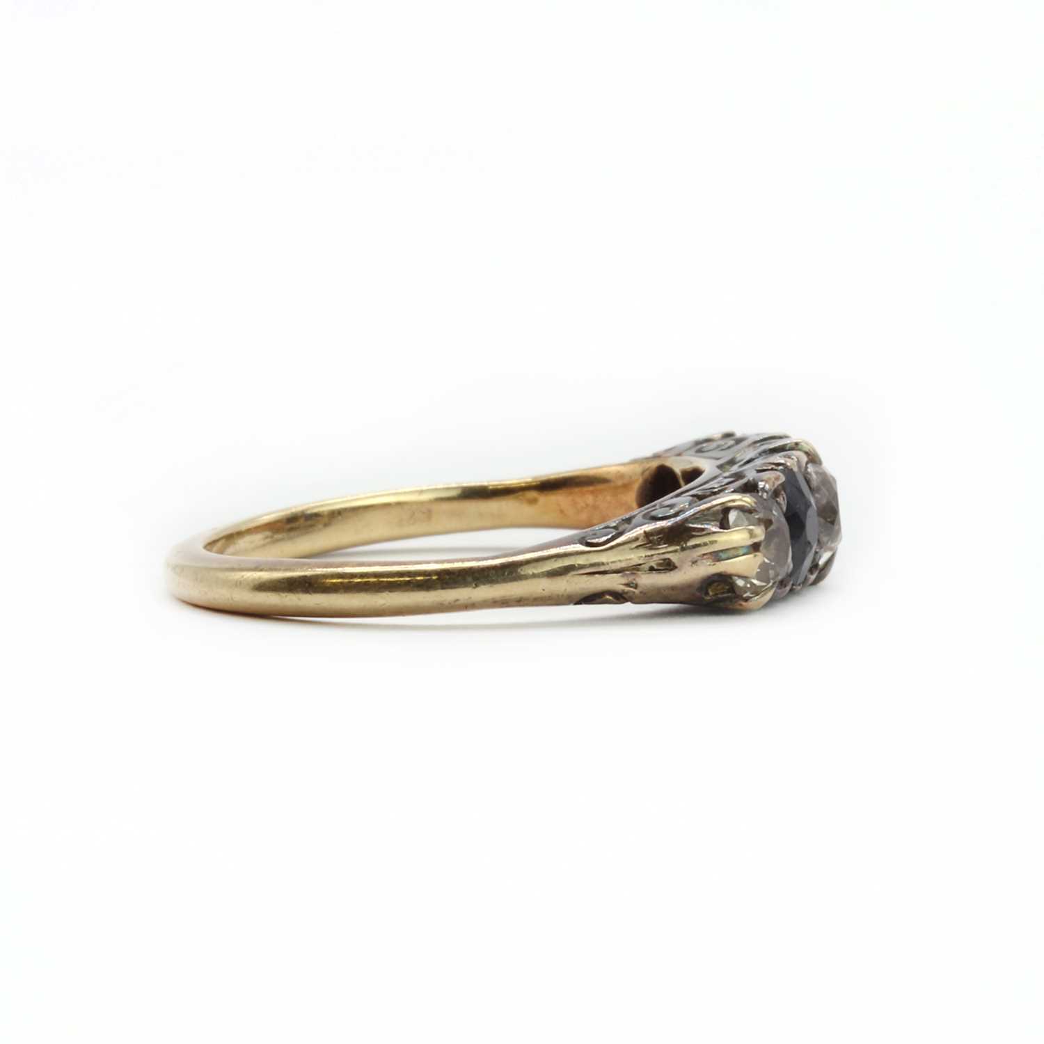 A gold diamond and sapphire five stone carved head ring, - Image 2 of 3