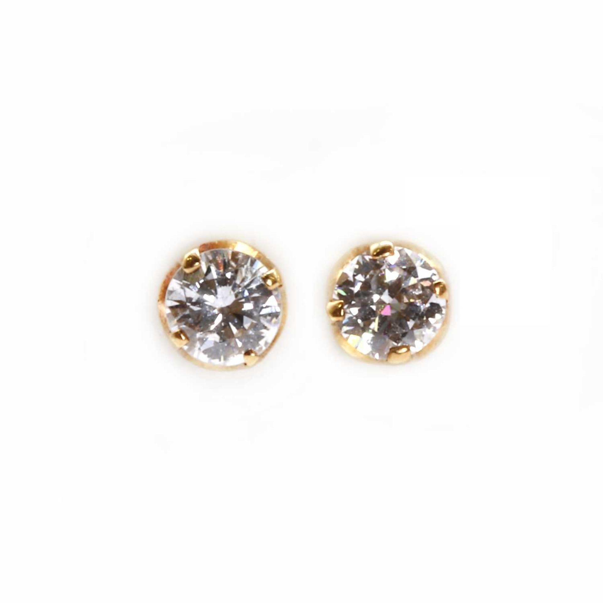 A pair of single stone diamond stud earrings,