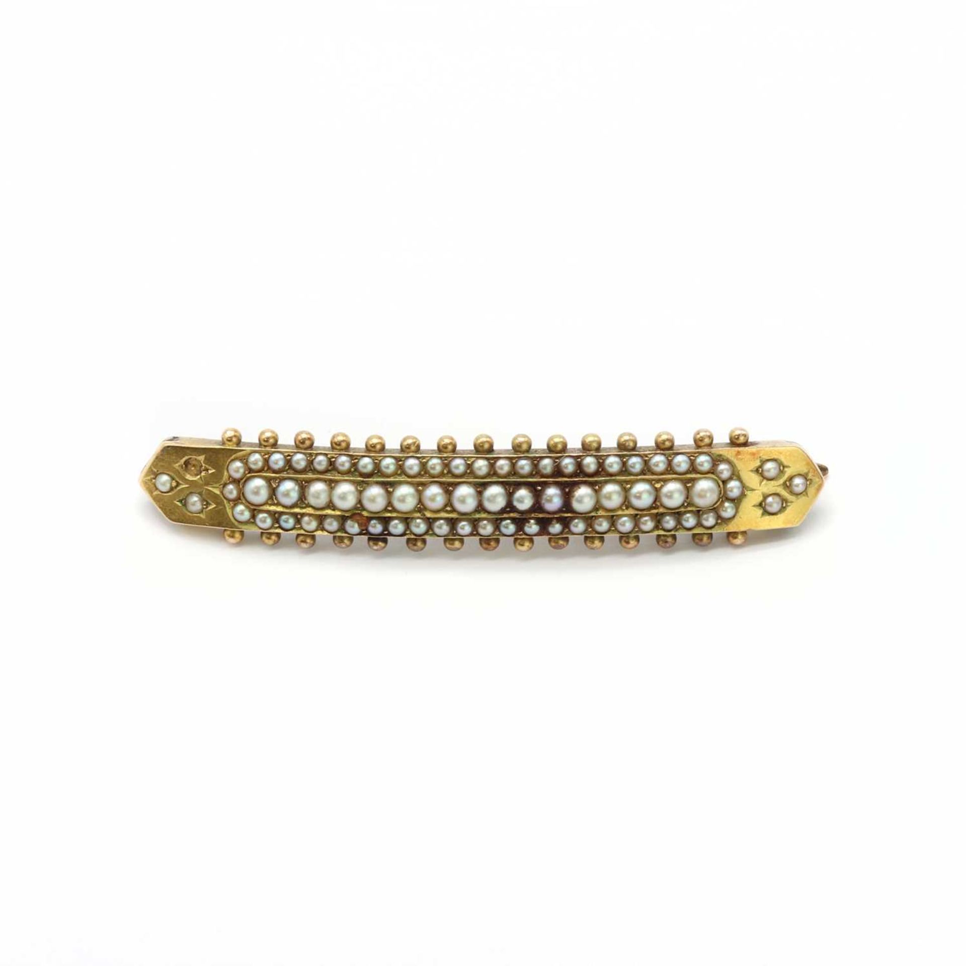 A gold and split pearl curved bar brooch,