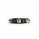 A gold diamond and sapphire five stone carved head ring,