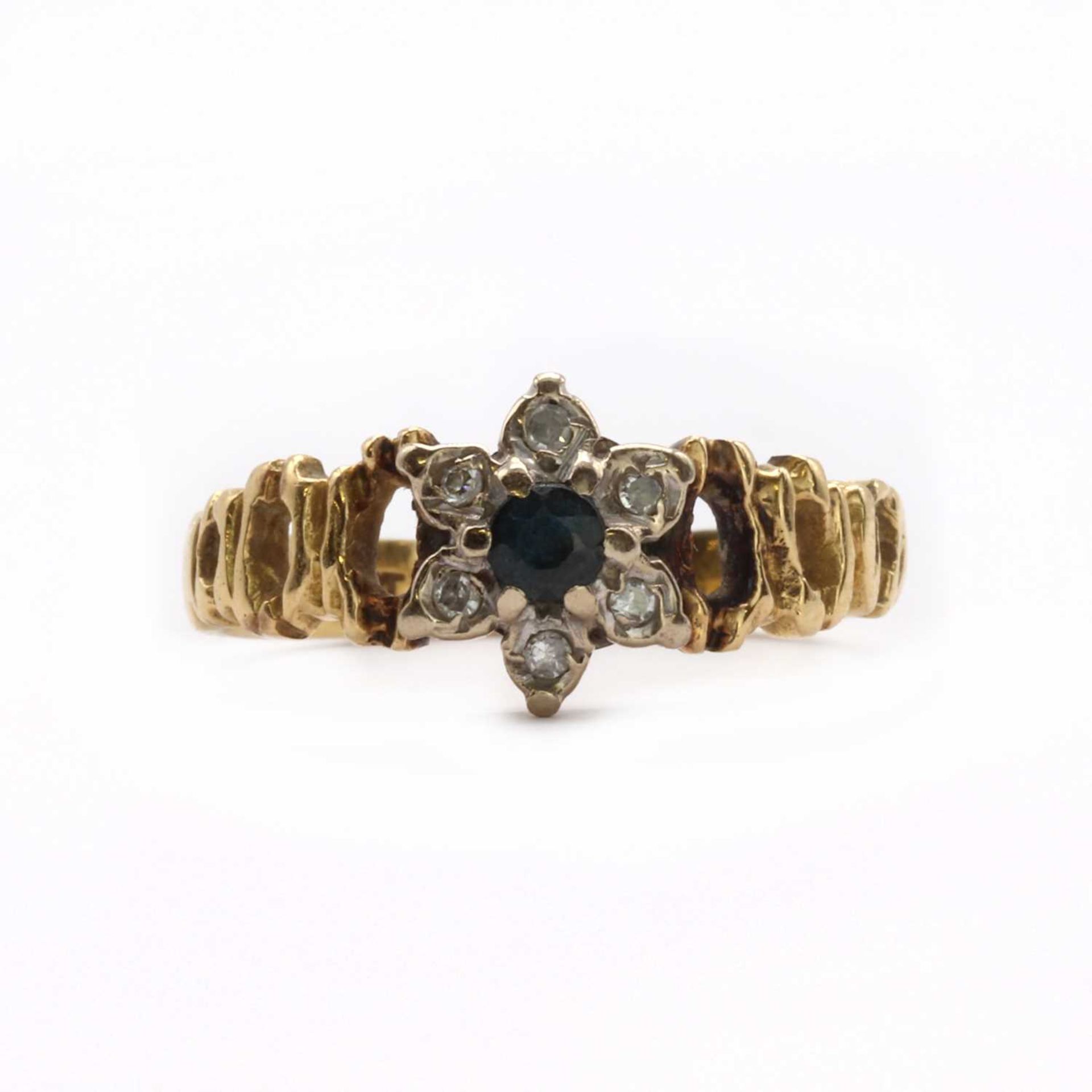 A gold sapphire and diamond daisy cluster ring,