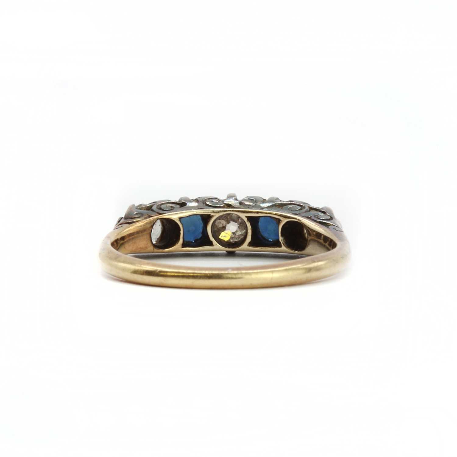 A gold diamond and sapphire five stone carved head ring, - Image 3 of 3