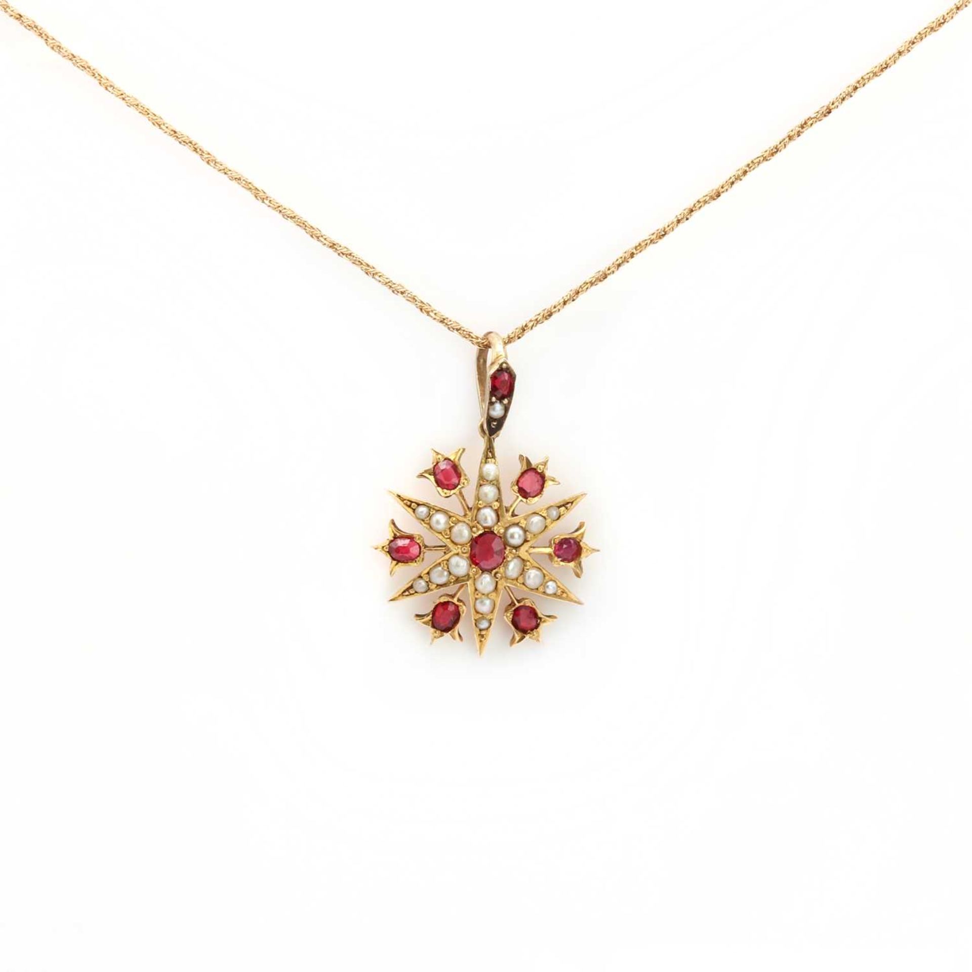 A late Victorian gold synthetic ruby and split pearl starburst pendant,