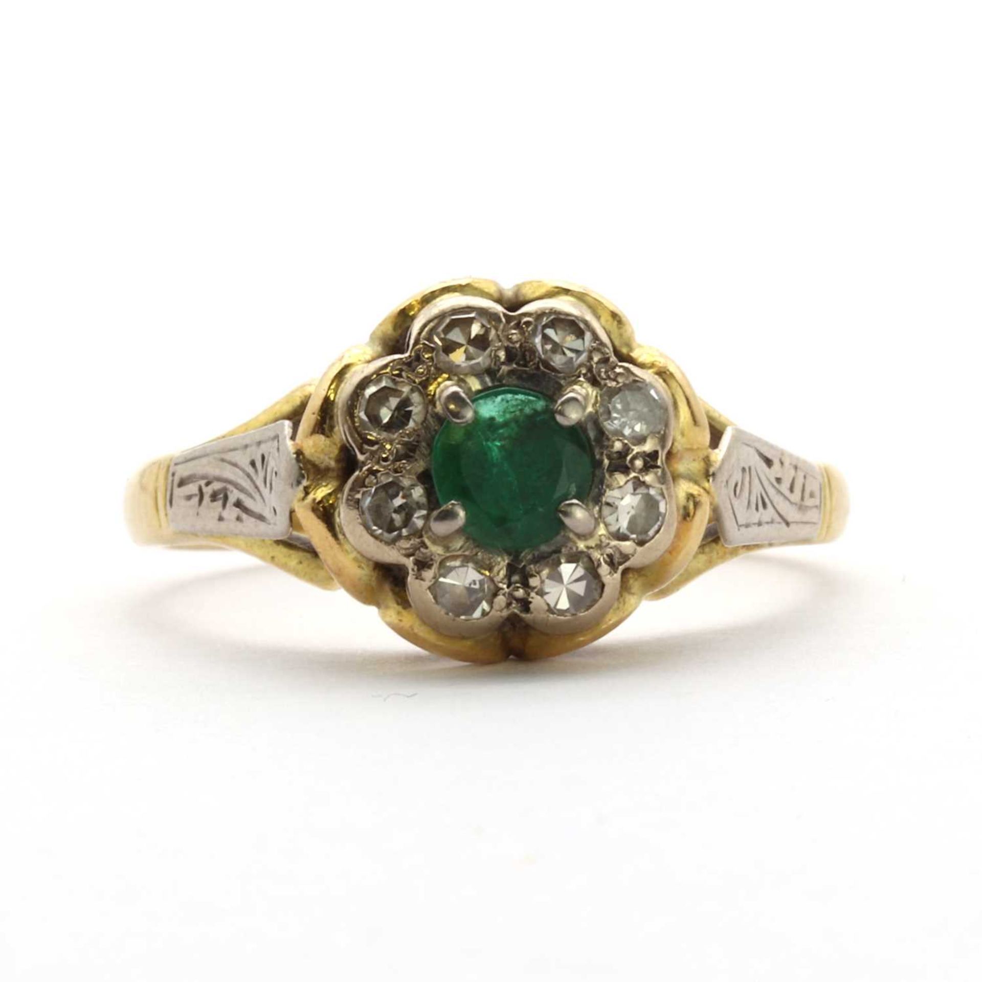 A two colour gold emerald and diamond floral cluster ring,