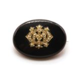 A Victorian onyx and split pearl oval memorial brooch, c.1890,