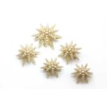 A set of five graduated mid 19th century pearl and seed pearl star brooches,