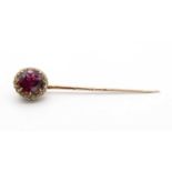 An Edwardian almandine garnet and diamond cluster stick pin,