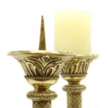 A pair of Edwardian ecclesiastical cast brass candlesticks,