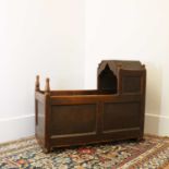 An oak hooded cradle,