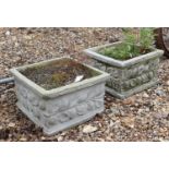 A pair of composite stone planters