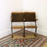 A pair of beech and cast iron cinema seats