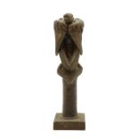 A bronze of an angel seated on a column