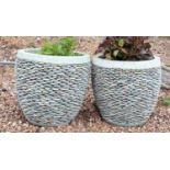 A pair of pebble stone garden planters