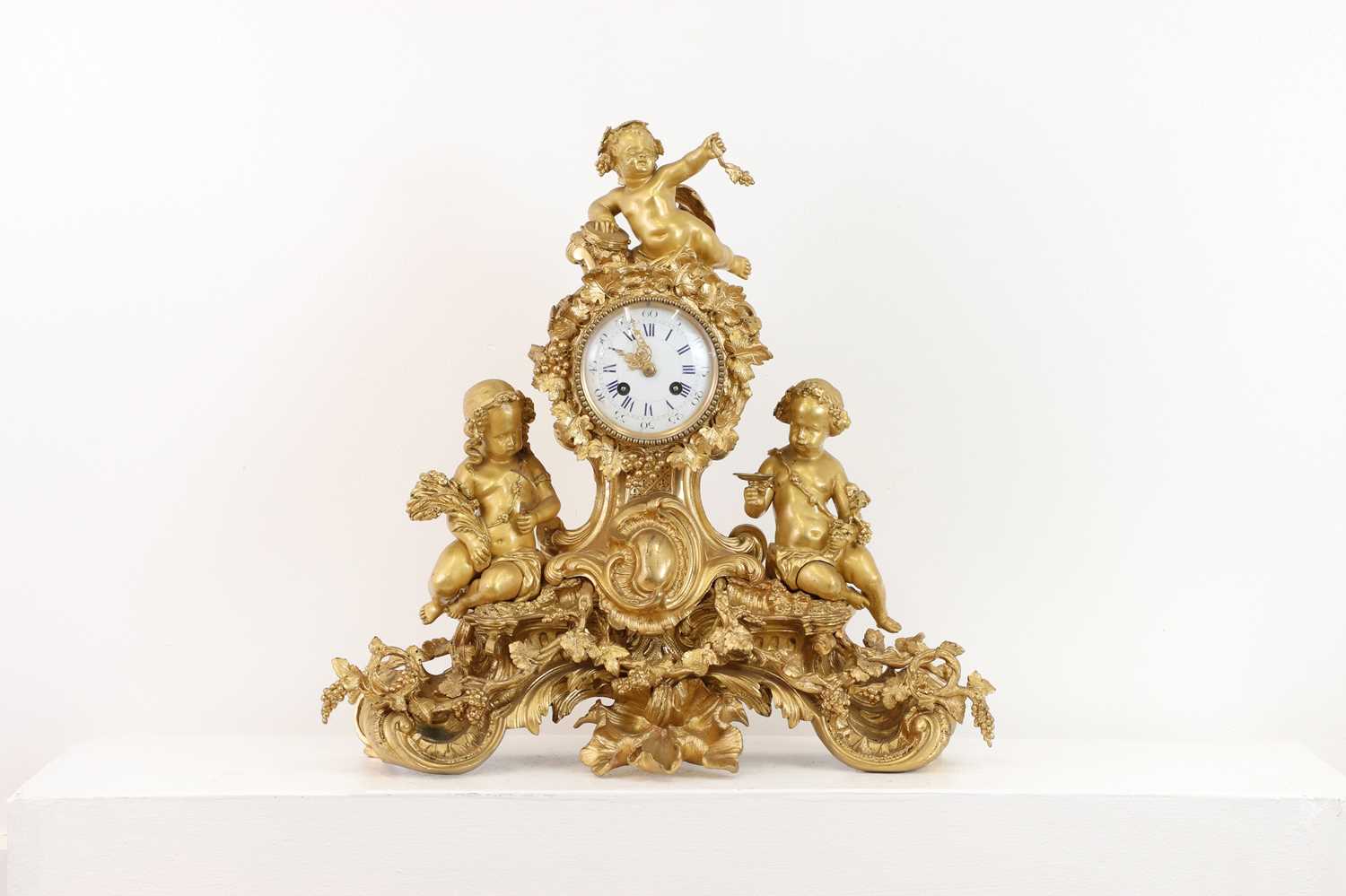 A gilt-bronze mantel clock,