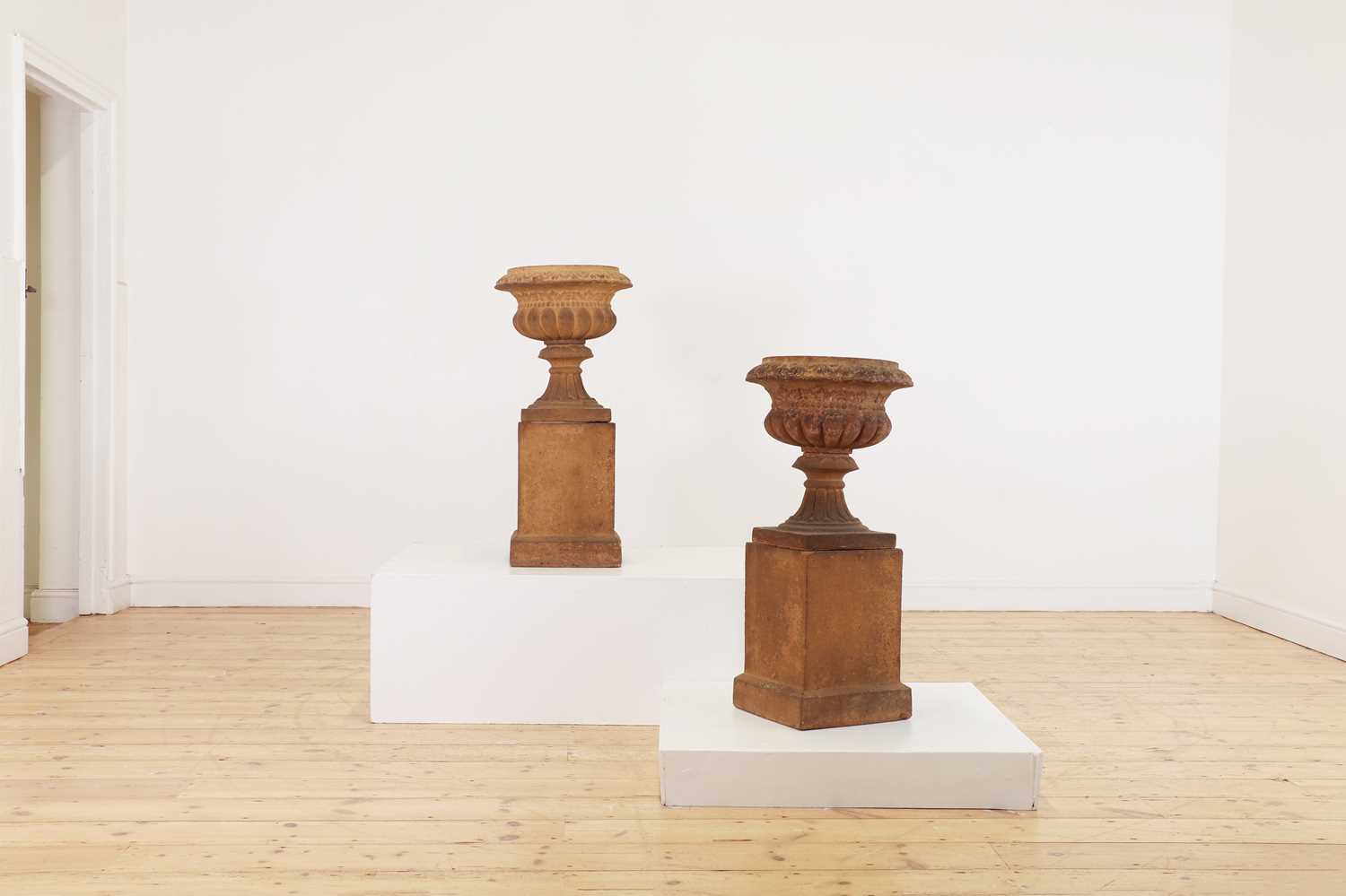 A pair of terracotta campana urns,