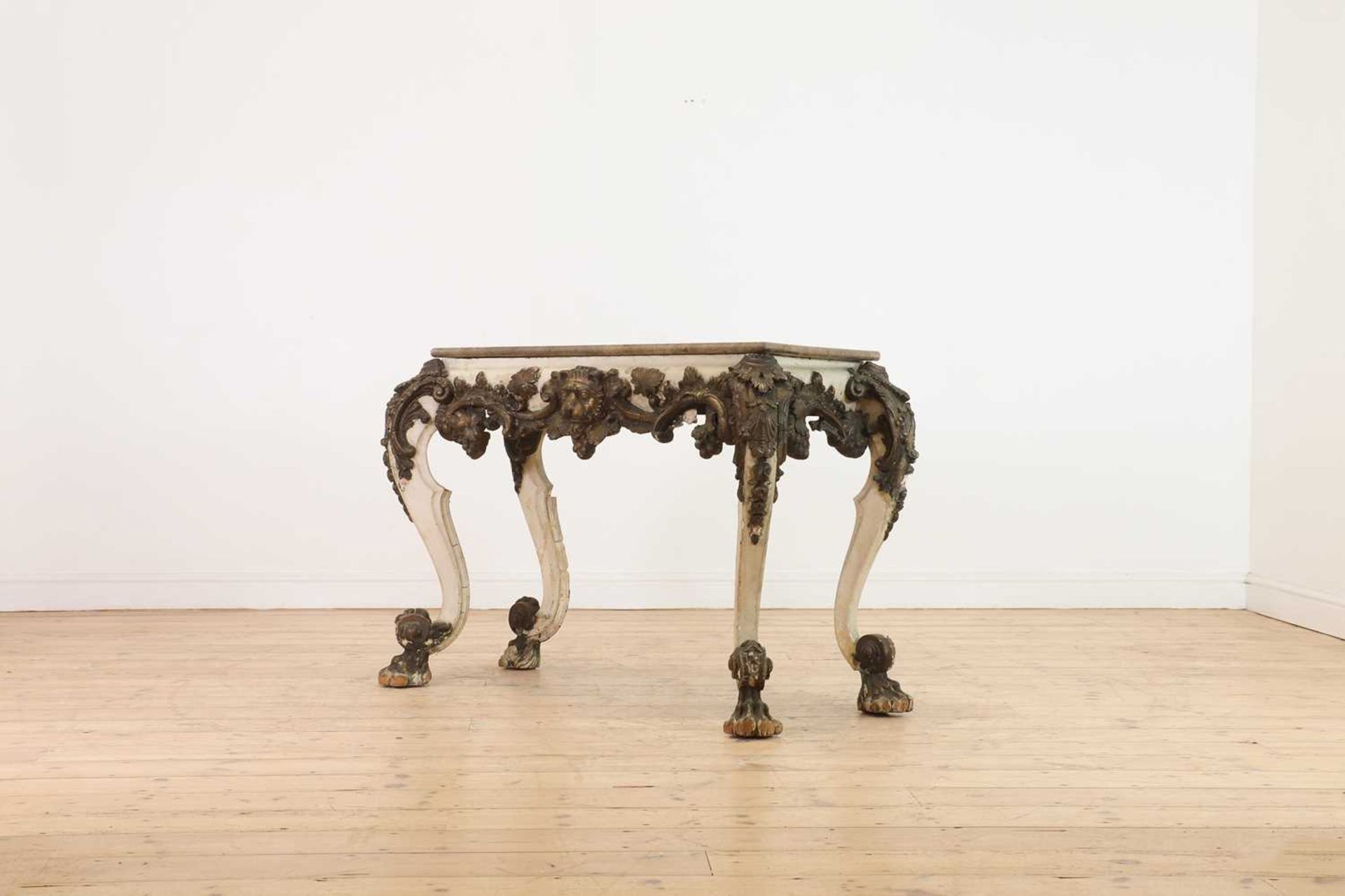 A carved and painted wood and composition pier table,