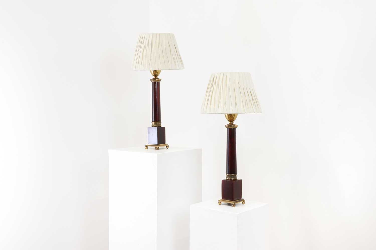 A pair of red Lucite and brass table lamps,