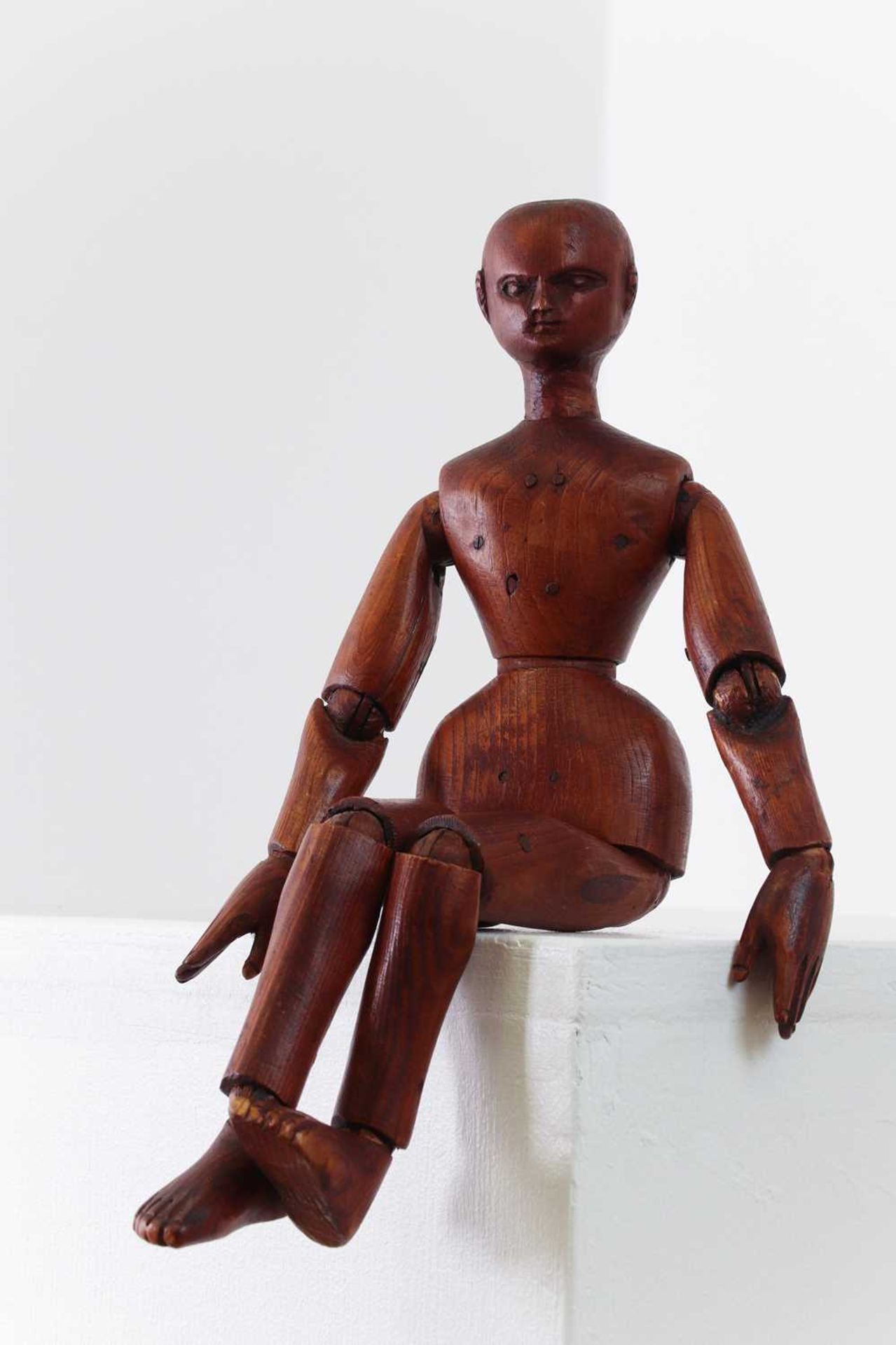 A carved and stained pine artist's lay figure,