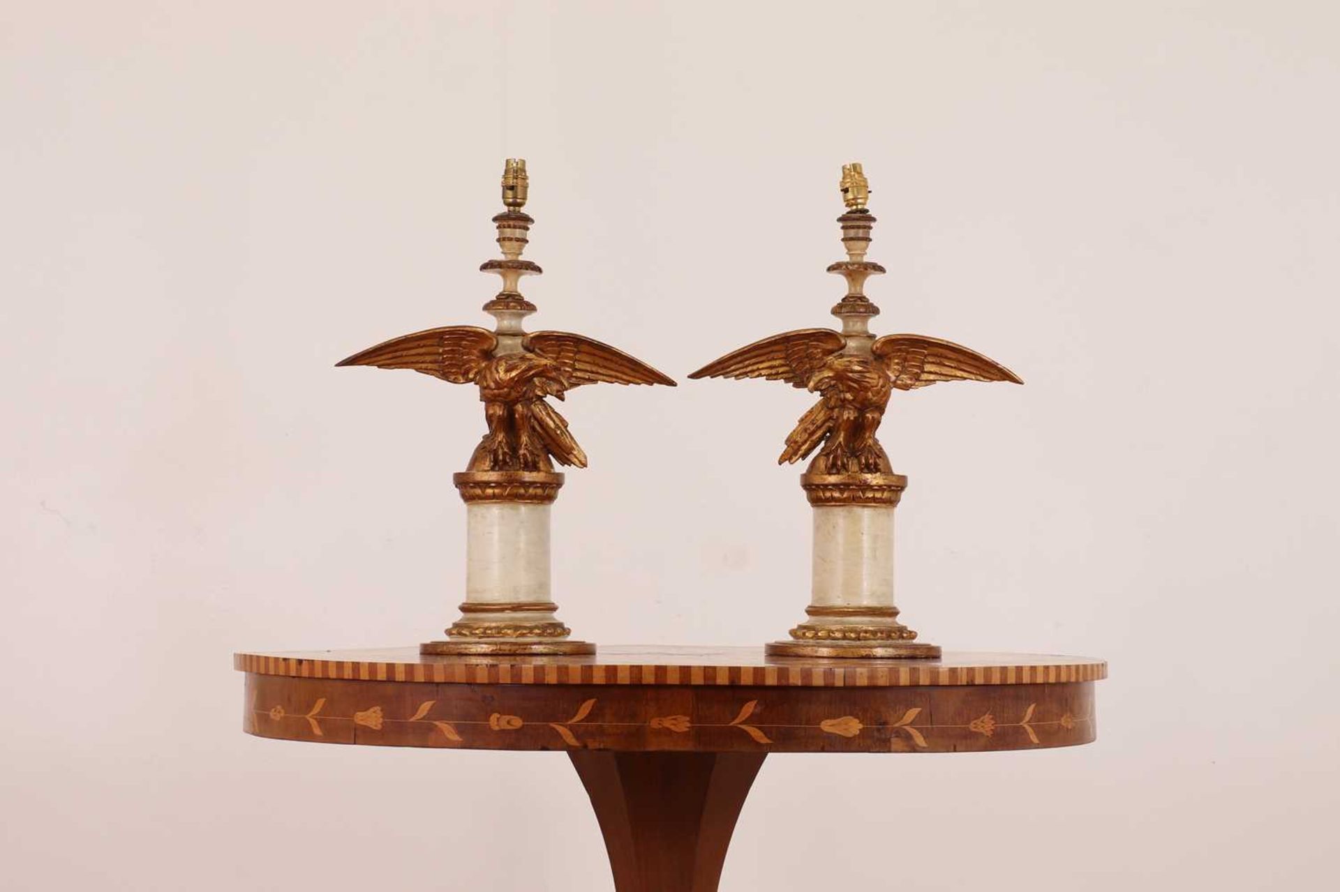 A pair of painted and giltwood table lamps,