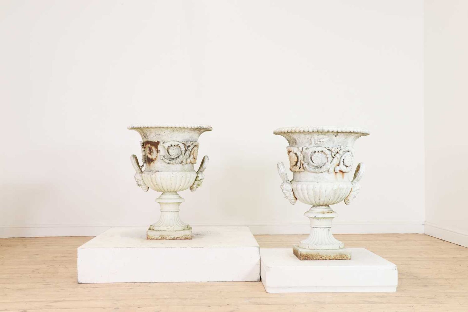 A pair of Victorian painted cast iron urns,