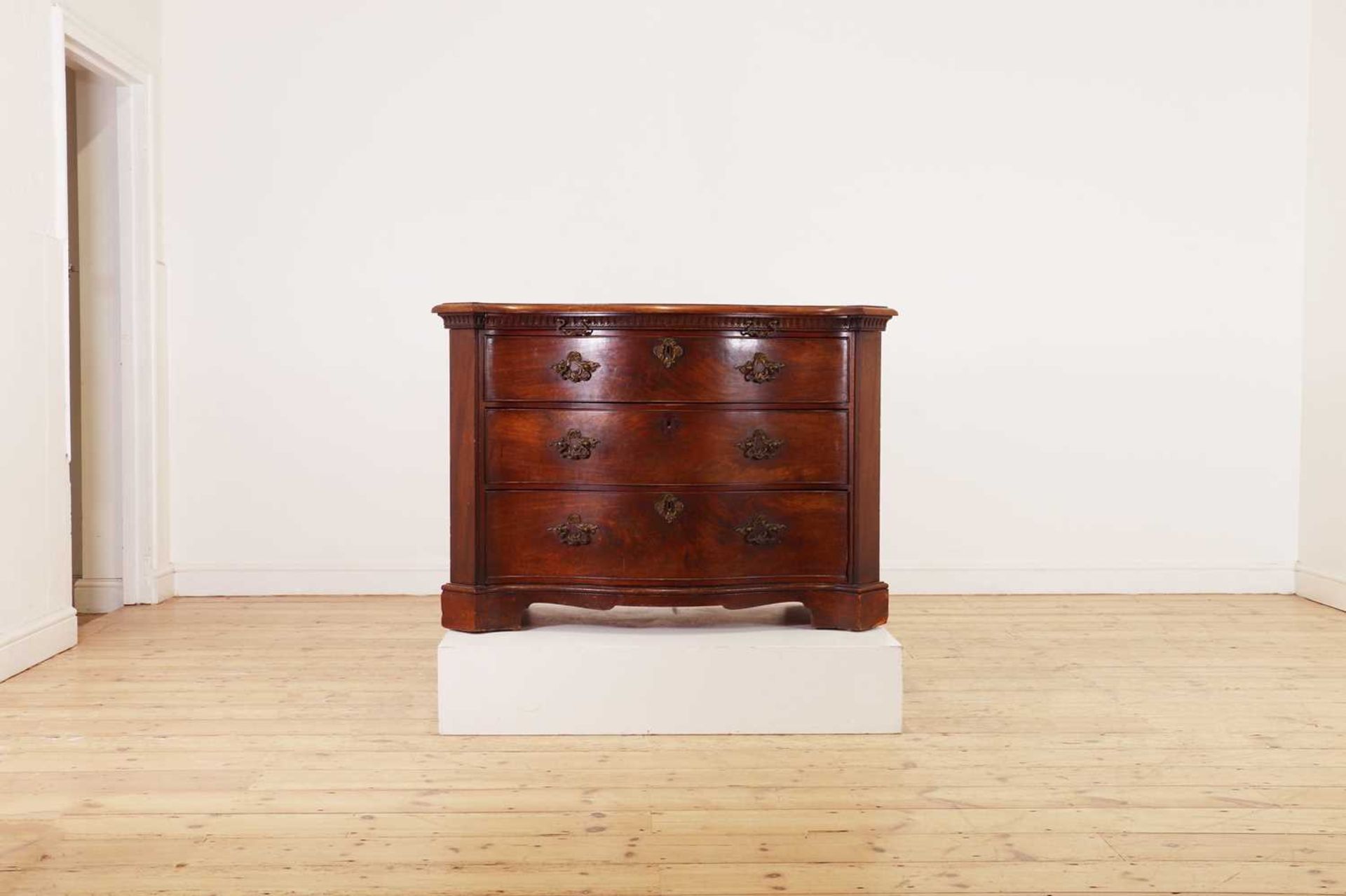 A George III mahogany serpentine commode,