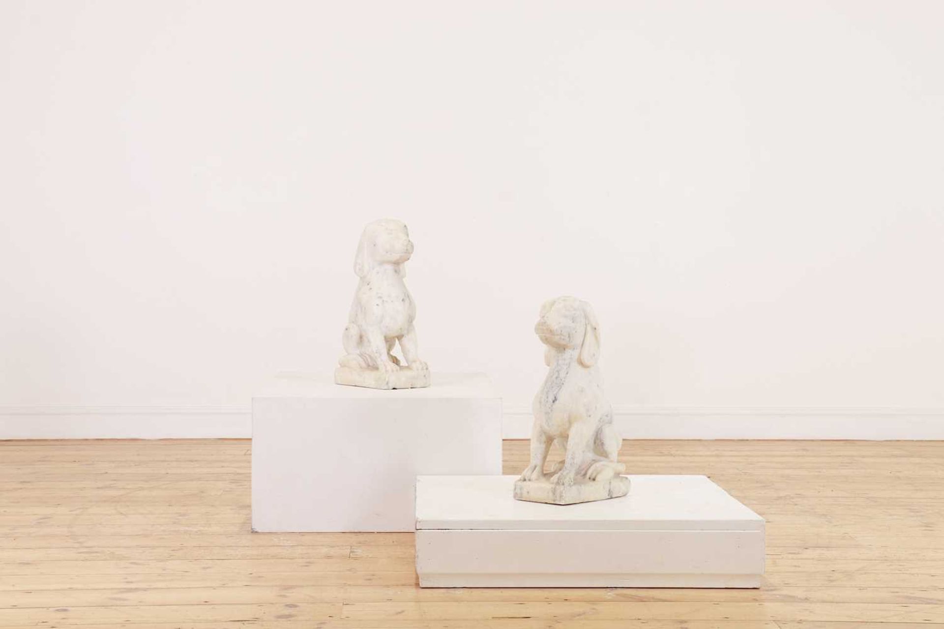 A pair of Carrara marble dogs,