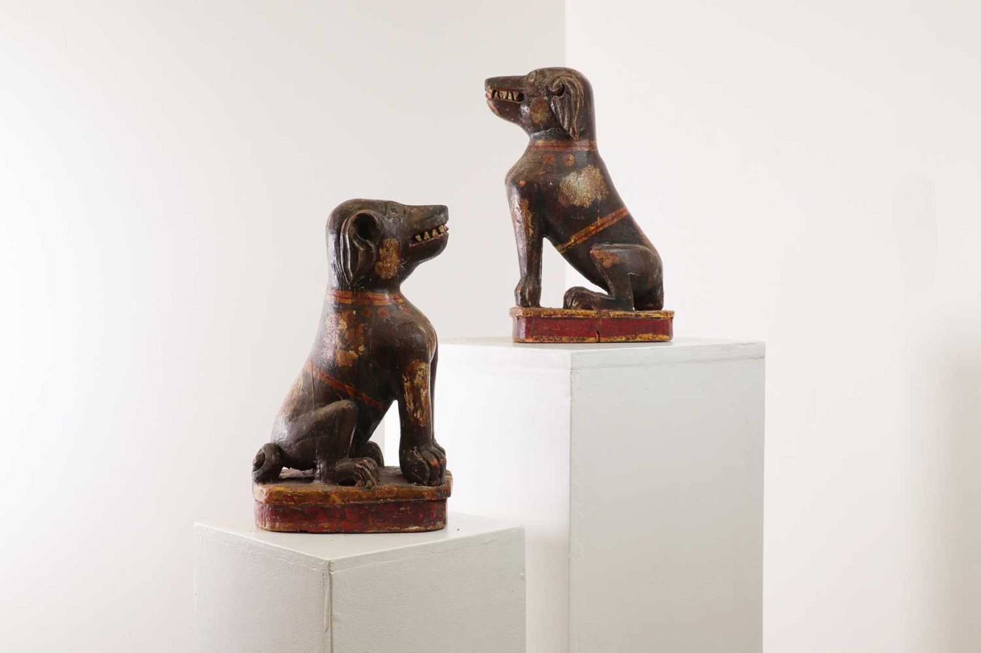 A pair of painted wooden dogs,