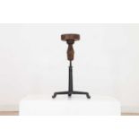 An adjustable oak sculpture stand,