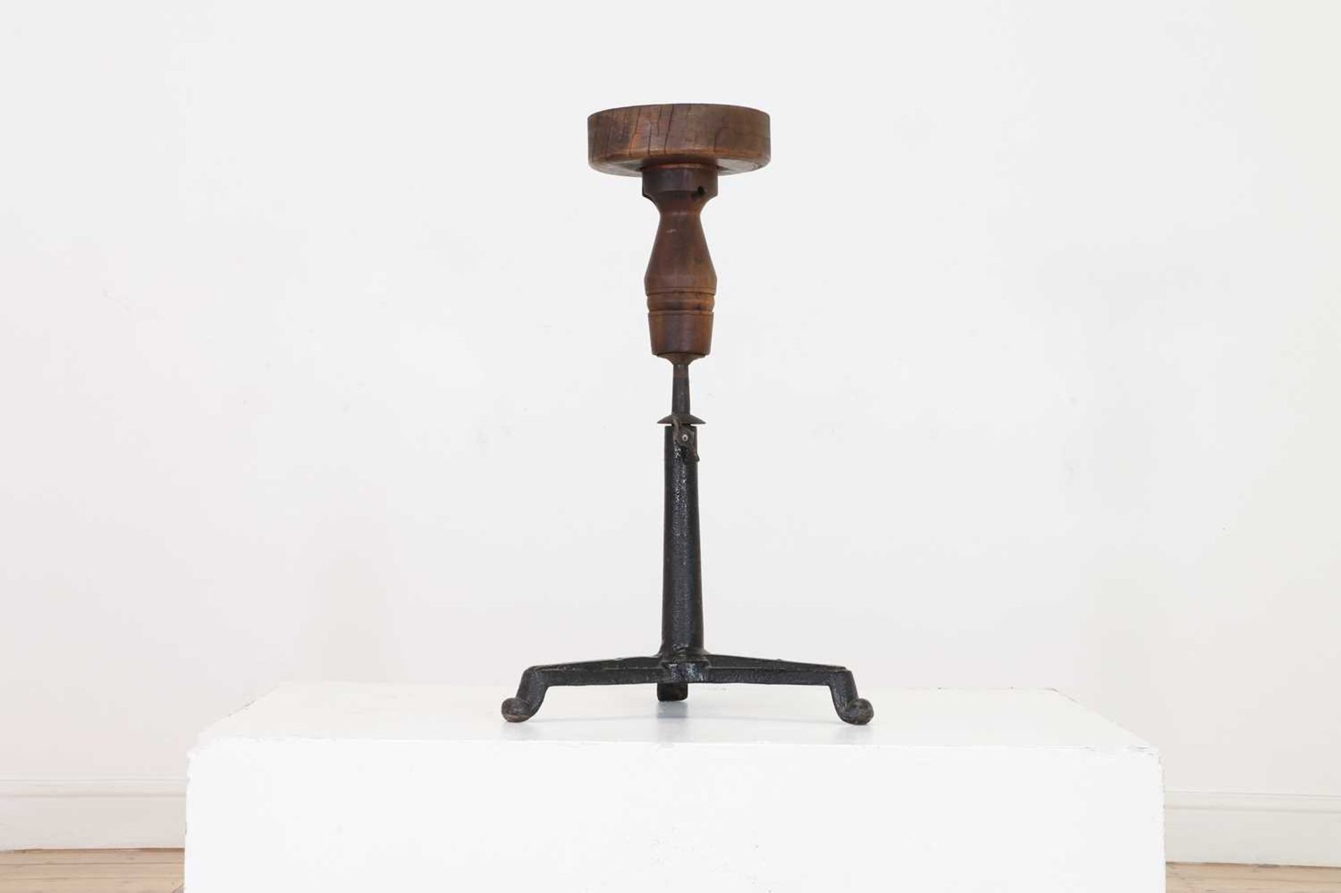 An adjustable oak sculpture stand,
